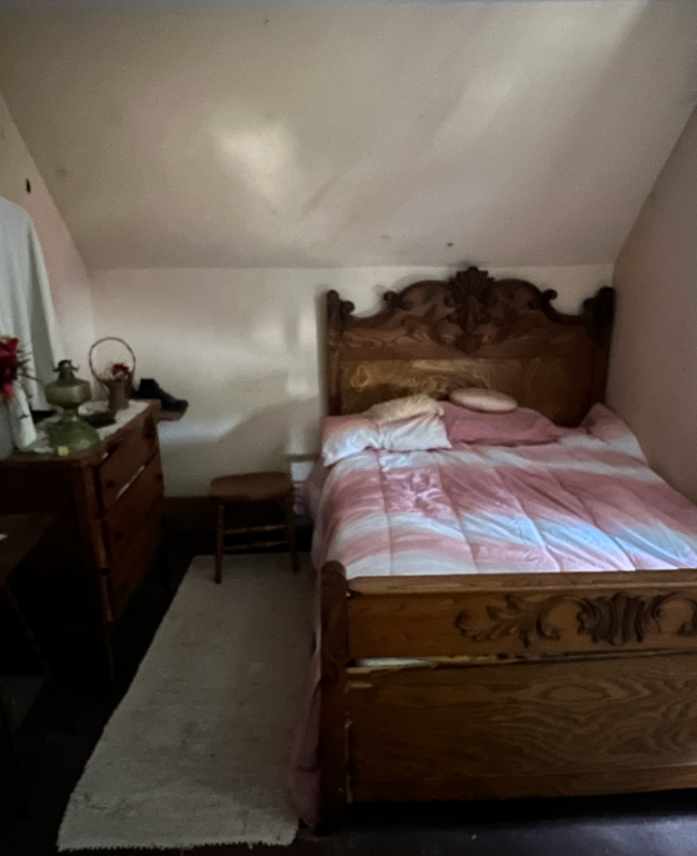 A pink bed in a bedroom of the Villisca House